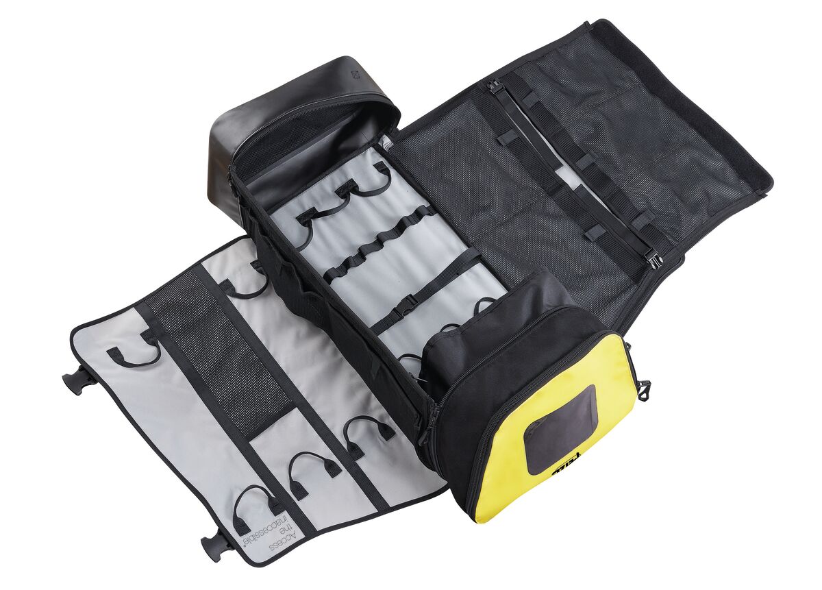 Black and yellow tool roll with tools on a white background