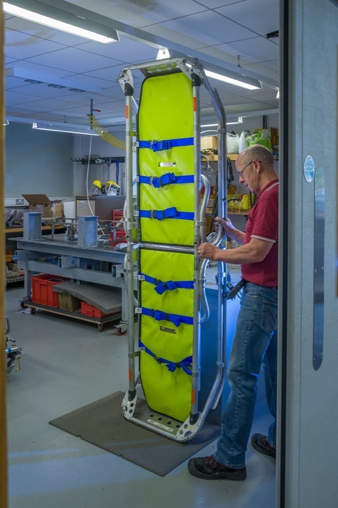 Person using a mechanical stretcher in a medical setting