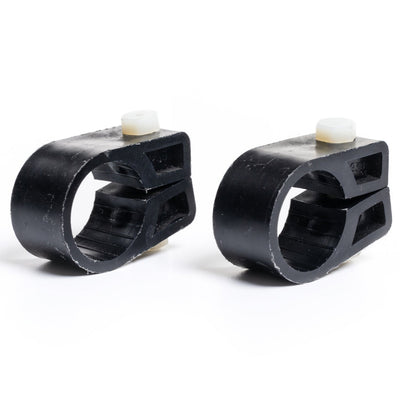 Two black plastic components with white knobs on a white background