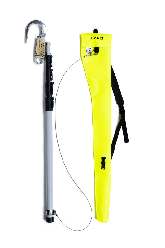 A long gray and black pole with a metal hook at one end, shown alongside a bright yellow carrying case with a black strap on a white background.