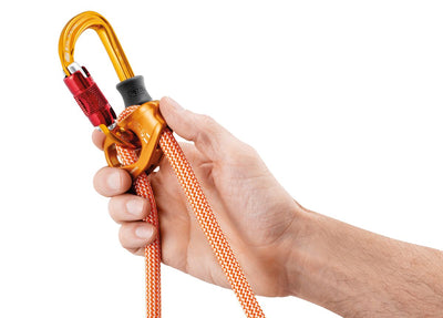 Hand holding a climbing device with orange rope against a white background