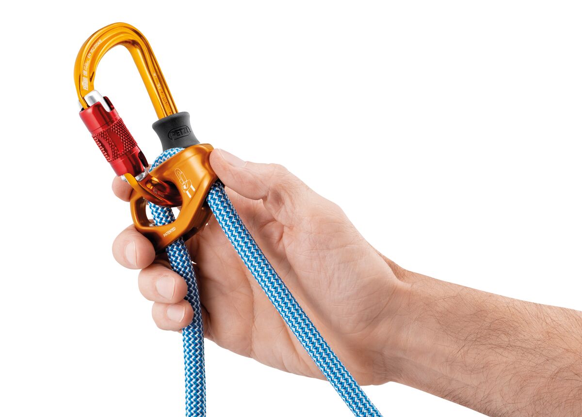 Hand holding a climbing rope with orange carabiners against a white background