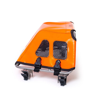 Orange bike cargo box with black straps on a white background