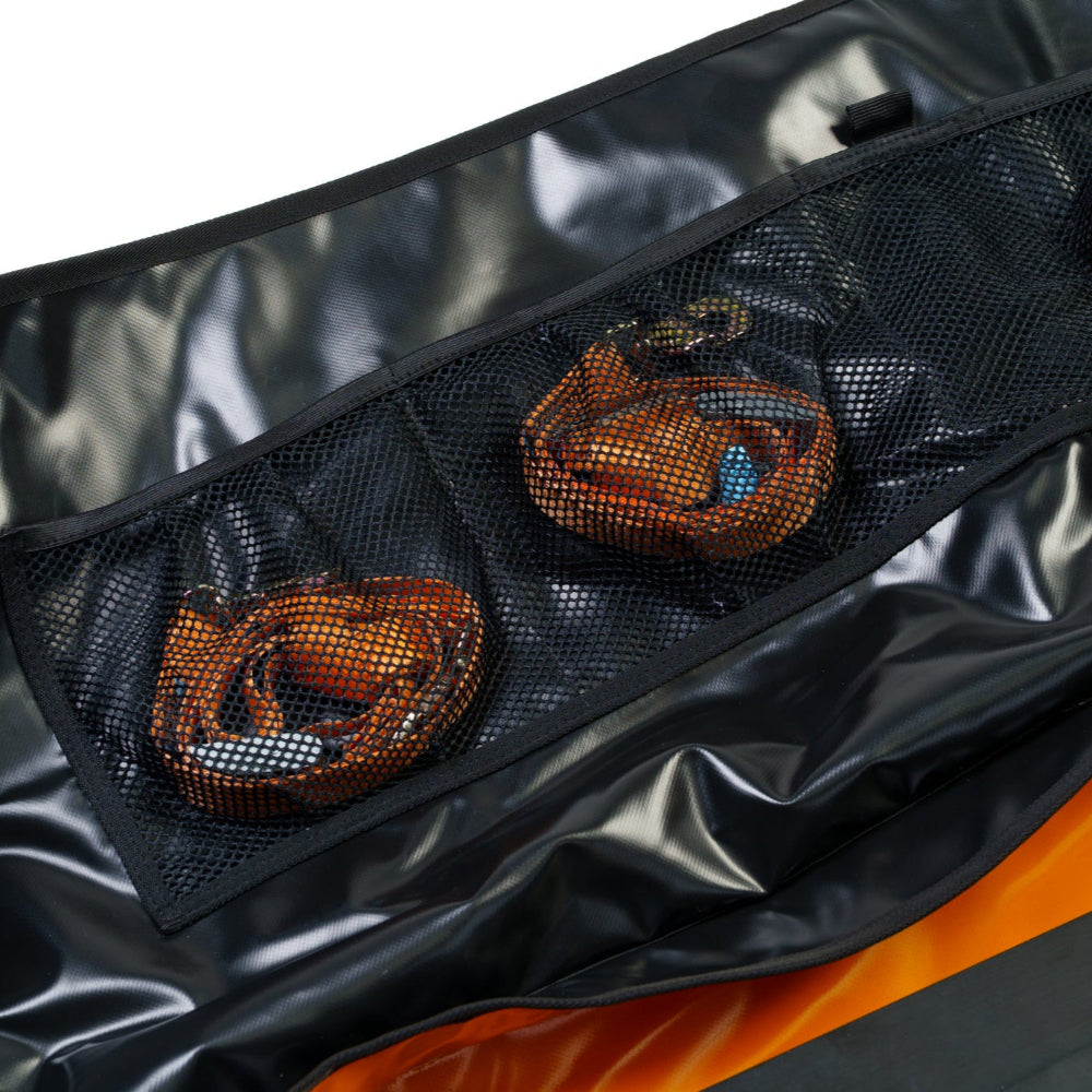 Black mesh pouch with orange and blue decorative elements on a reflective black surface