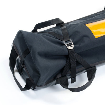 Black duffel bag with straps on a white background