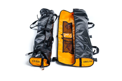 Two backpacks, one black and one orange with gray accents, on a white background.