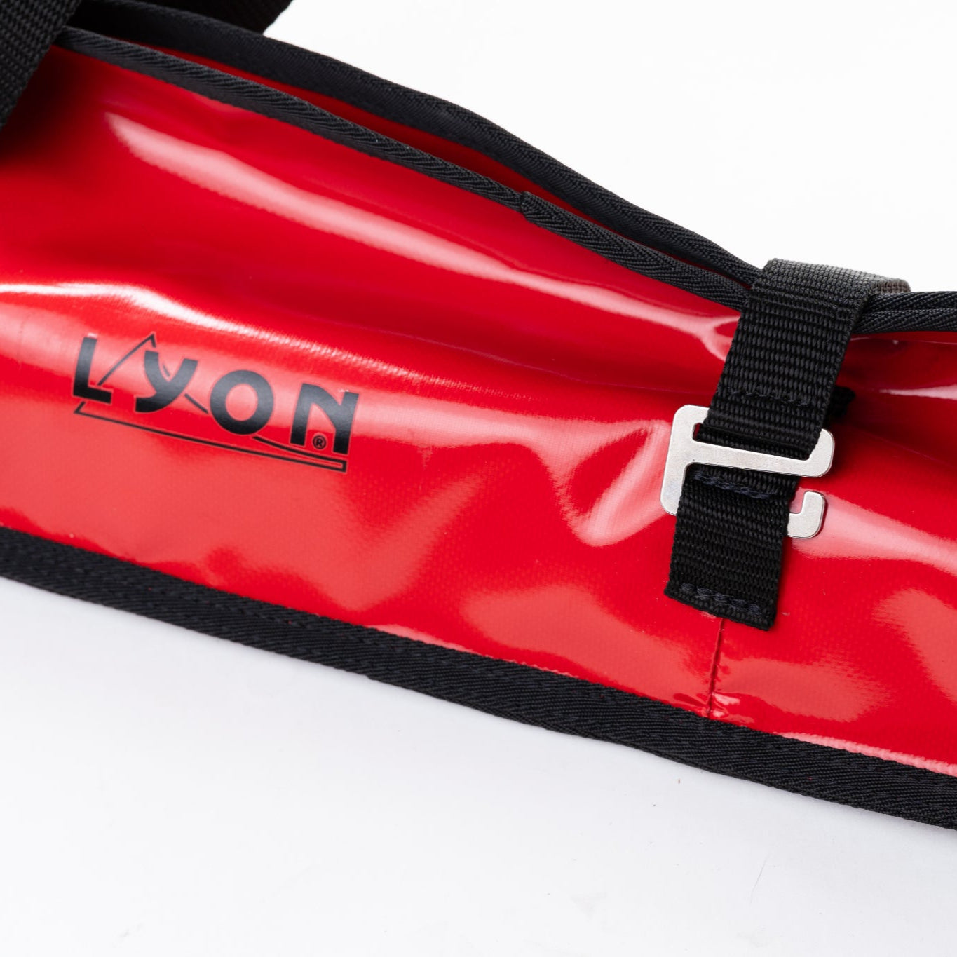 Red bag with black straps and 'LYON' branding on a white background