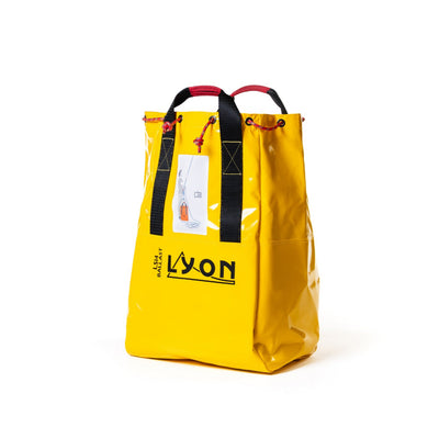 Yellow bag with black straps and 'LYON' branding on a white background