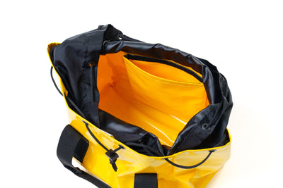 Yellow and black duffel bag on a white background
