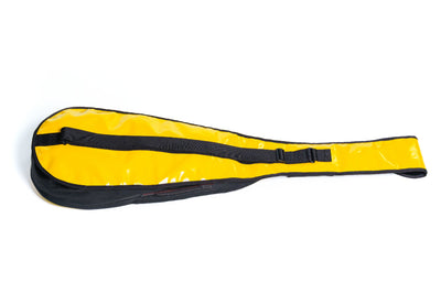 Yellow paddle with black strap on a white background