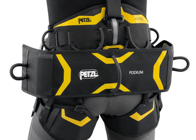 Black and yellow Petzl podium harness on a white background