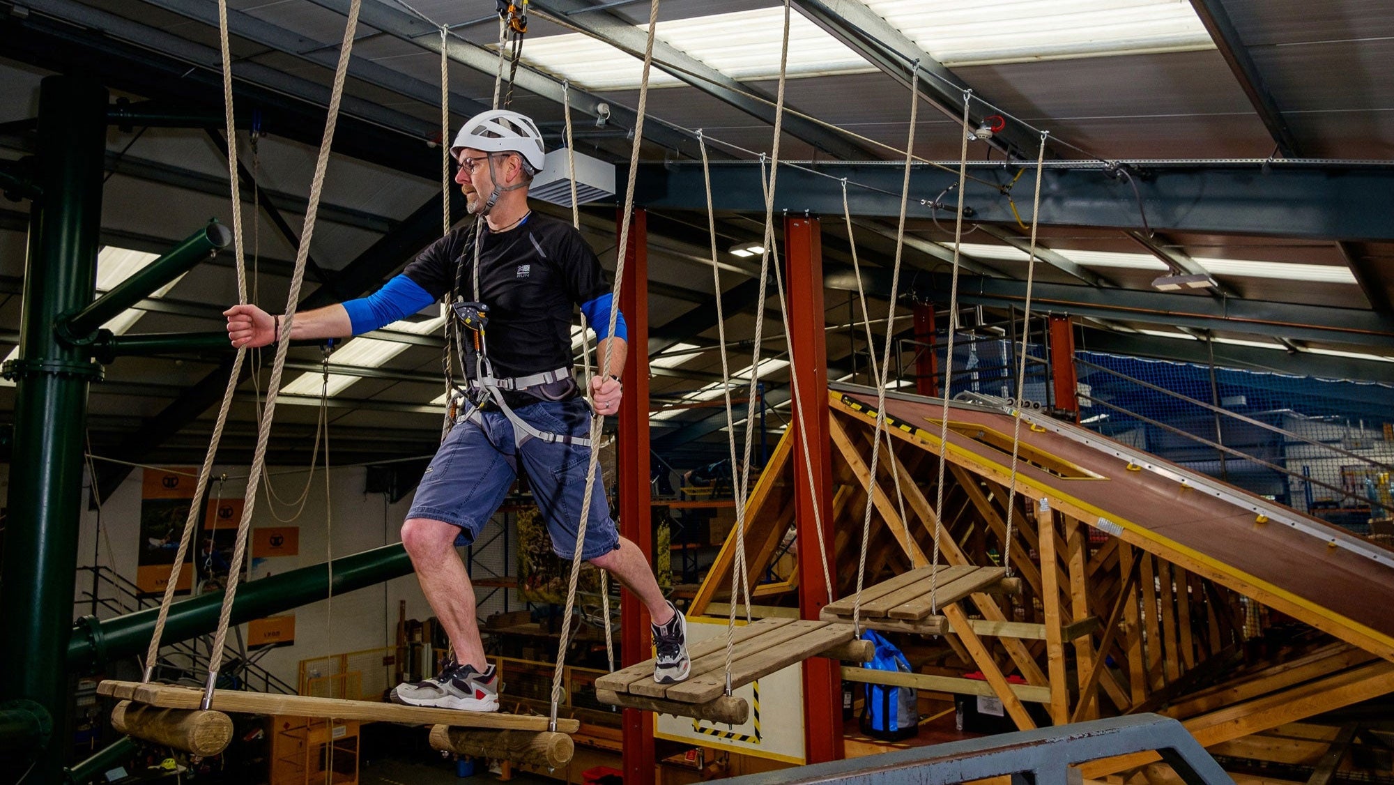 Person on a high ropes course in an indoor setting