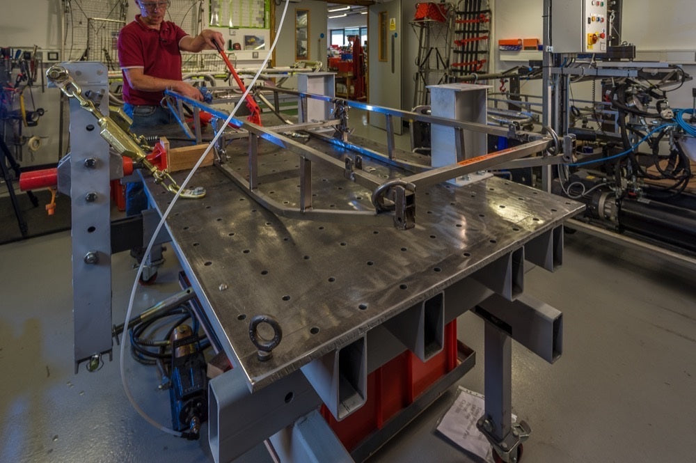 Person working on a metal structure in a workshop setting